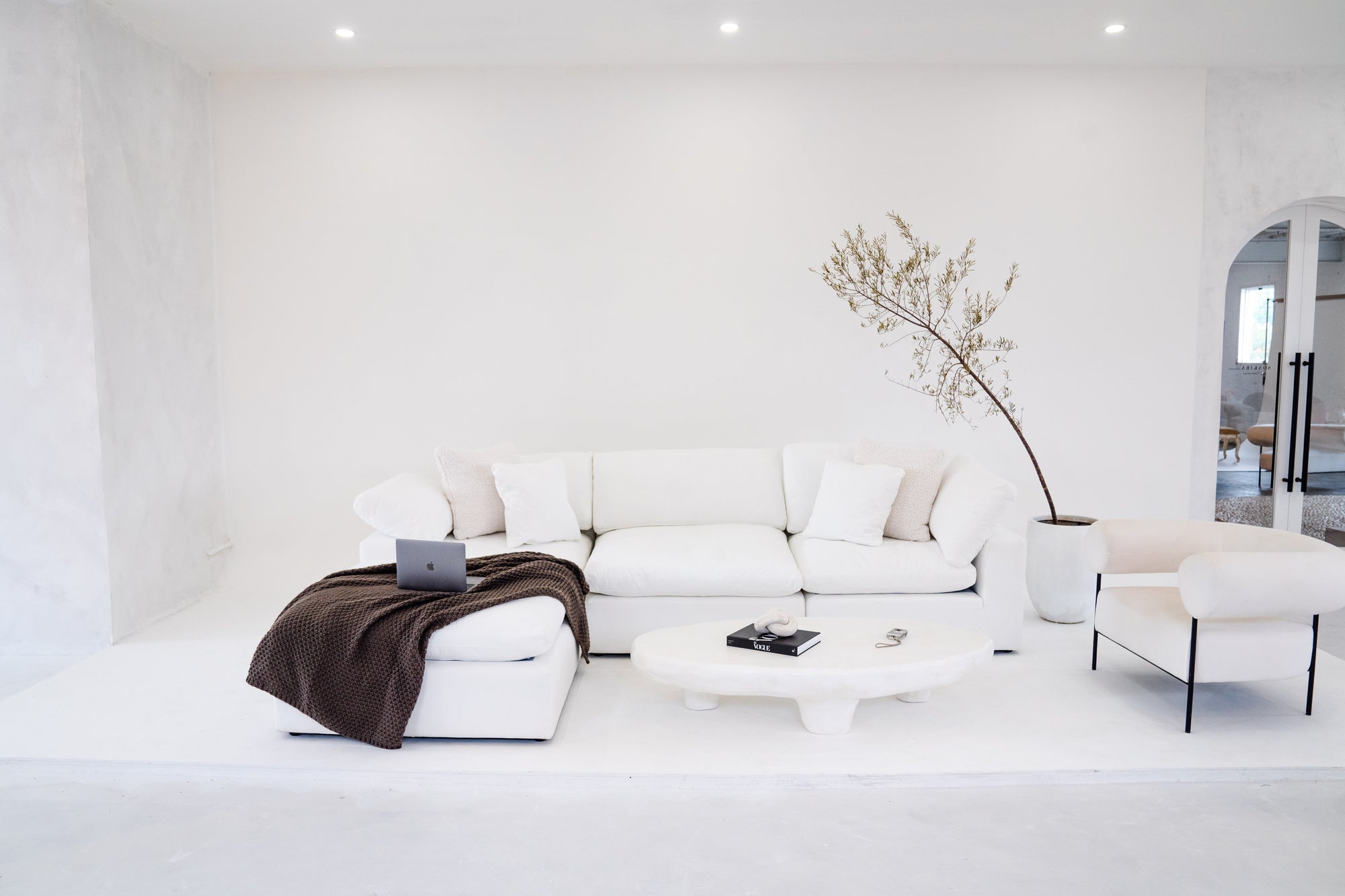 Fin's Furniture showroom featuring a white cloud sectional sofa